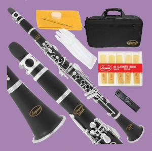Clarinet with case and various accessories on purple background