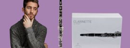 Bearded man looking pensively at Buffet B12 clarinet with box on purple background